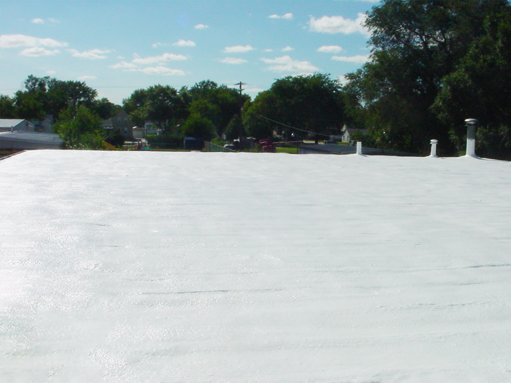 Completed spray foam roofing project at Logan Street Radiator, showcasing the roof and spray foam application for waterproofing, Norfolk, NE